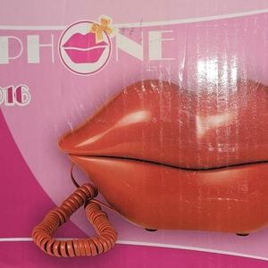 A retro phone for a Land-line. The phone is GOLD. There's a small nick on side.